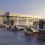 a building with a large glass frontrooftop terrace with lounge chairs and city views