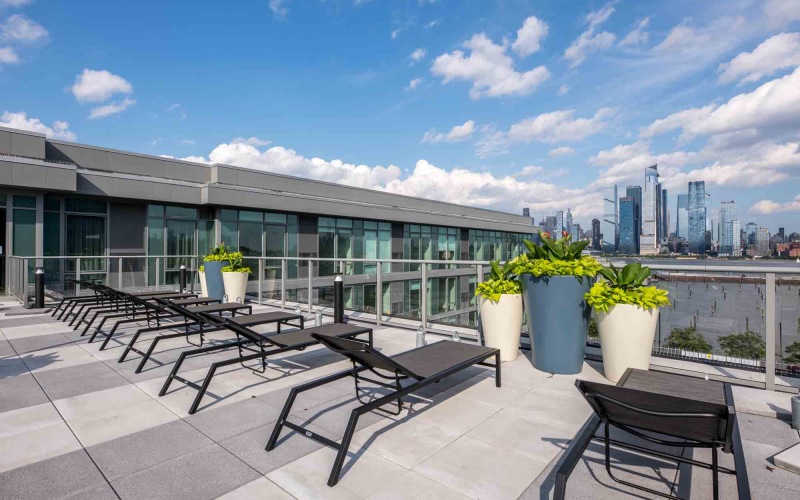 rooftop terrace with lounge chairs and city views