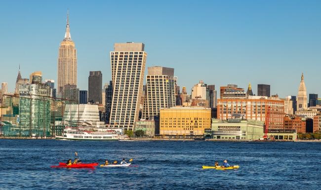 A beautiful community at the heart of all your passions people in kayaking along city skyline